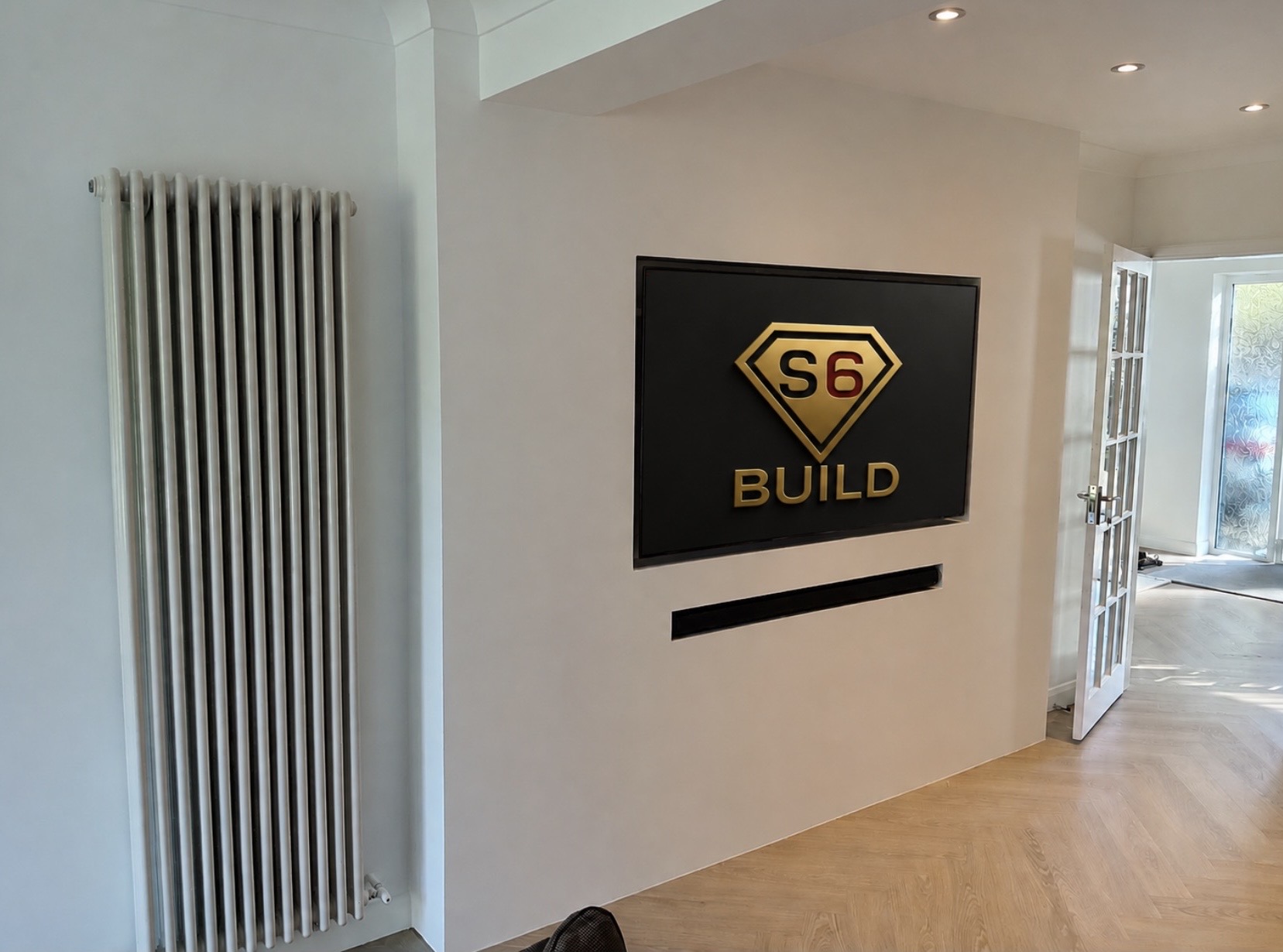 Minimal media wall with flush television recess and soundbar slot